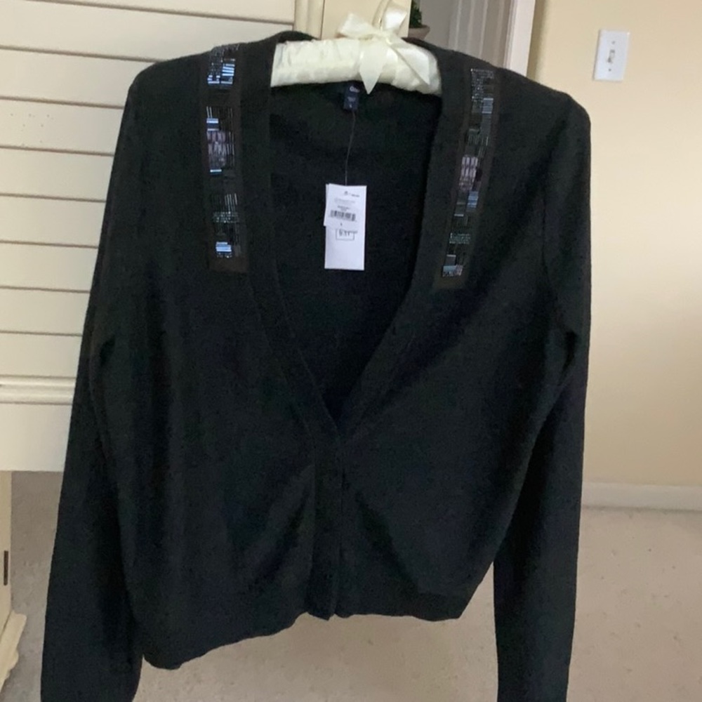 Dark grey cardigan sweater with beaded detail.